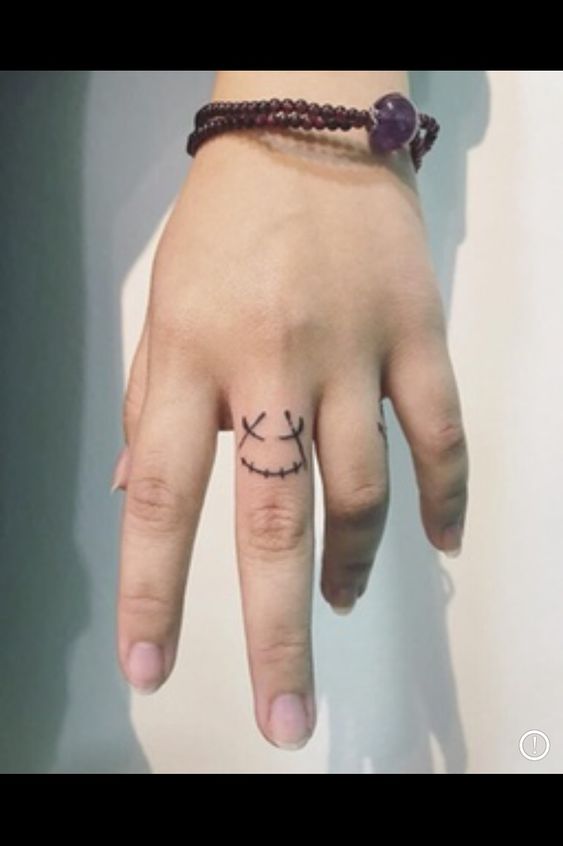 Smiley Face Tattoo on Finger